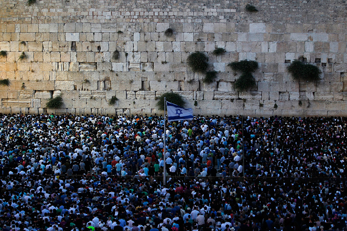 Israelis take part in a mass prayer at the Western Wall in Jerusalem's Old City, for the return of three teenagers who were abducted while hitch-hiking in the West Bank