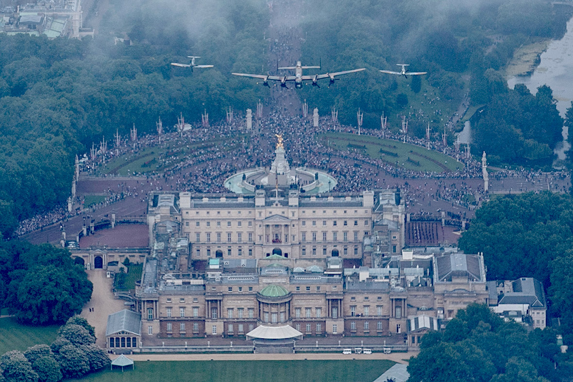 A Lancaster flanked by two Spitfires from the Battle of Britain Memorial Flight fly over Buckingham Palace as part of Her Majesty's Birthday Flypast during Trooping the Colour.