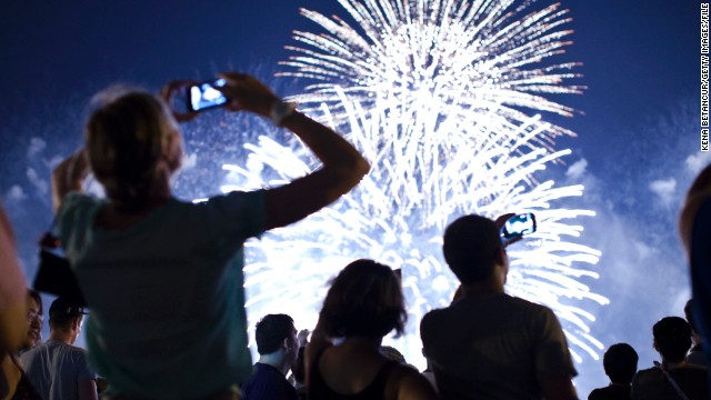 WEEHAWKEN, NJ - JULY 4: People watch fireworks light up the sky over New York City on July 4, 2013 in Weehawken, New Jersey. July 4th is a national holiday with the nation celebrating its 238th birthday. (Photo by Kena Betancur/Getty Images)
