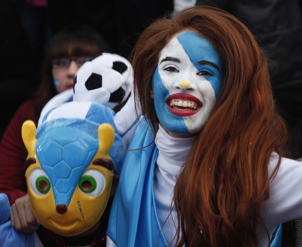 An Argentine fan celebrates at the end of the 2014 World Cup semi-final soccer match against the Netherlands