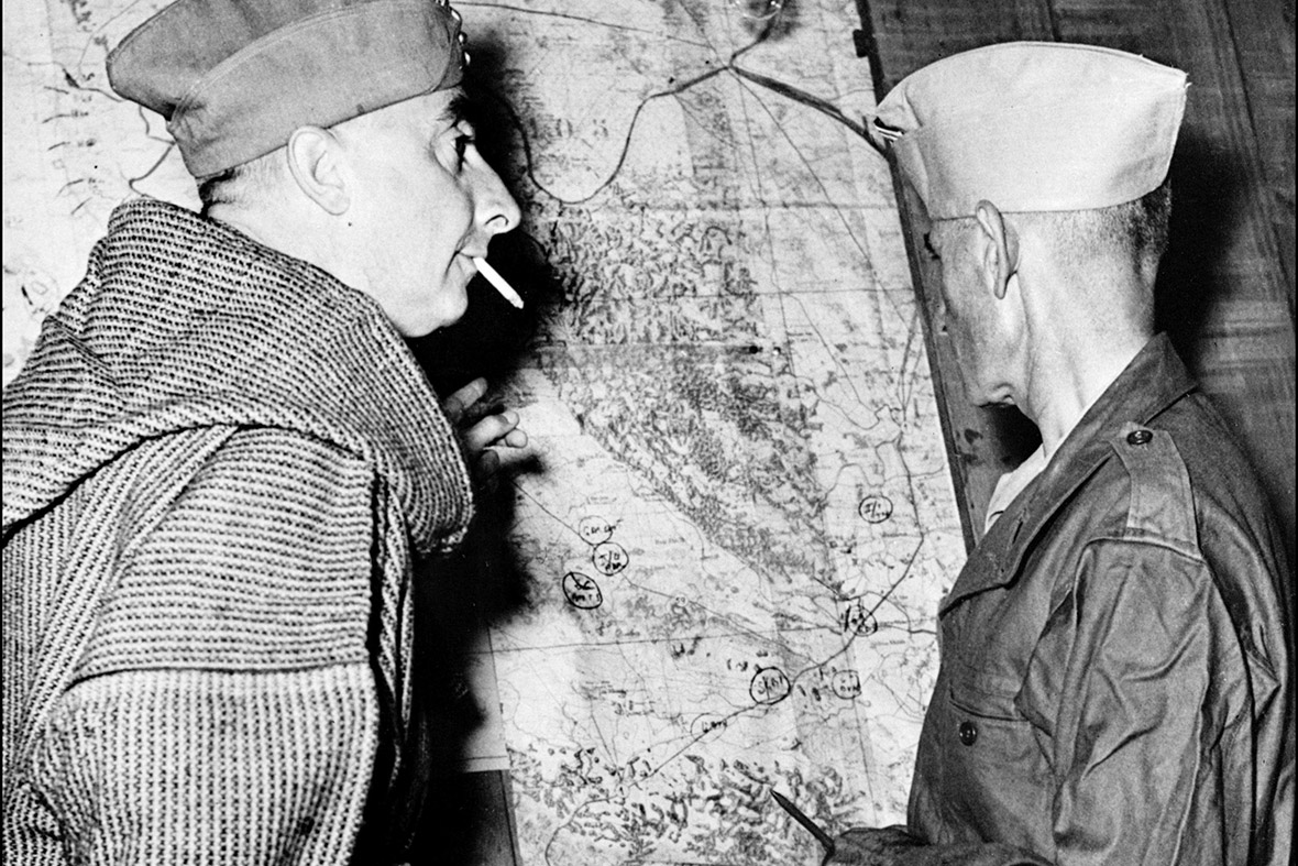 28 April1954: French General de Castries talks with an officer as they look at a map inside their underground headquarters. Nine days later the garrison fell to the Viet Minh after a bloody 57-day siege