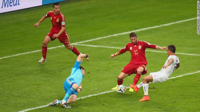 Eduardo Vargas, right, scores Chile's first goal, firing past Spanish goalkeeper Iker Casillas.