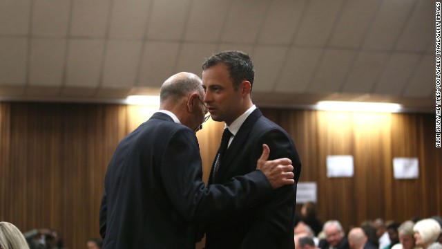 Pistorius speaks with his uncle Arnold Pistorius during his trial at the Pretoria High Court on Friday, September 12.