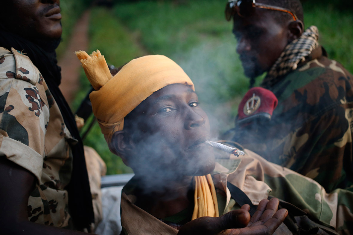 A Seleka fighter smokes during a patrol in the Central African Republic, close to the border with the Democratic Republic of Congo.