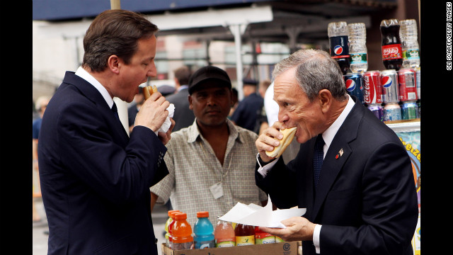 British Prime Minister David Cameron eats a hot dog with Bloomberg outside New York's Penn Station on July 21, 2010. Cameron met with Bloomberg and U.N. Secretary General Ban Ki-moon during his visit to New York. 