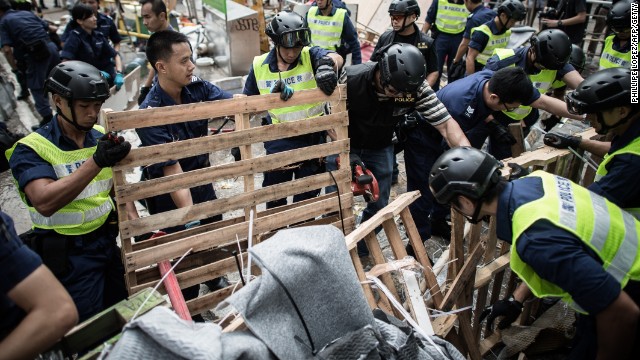 Police forces remove barricades of pro-democracy protesters in Hong Kong on October 14. 