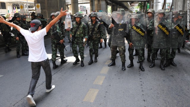 A protester confronts soldiers in riot gear during an anti-coup rally Sunday, May 25, in Bangkok.