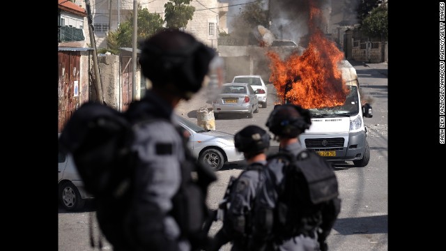 A van burns in Jerusalem during clashes between Palestinians and Israeli security forces on October 30. 