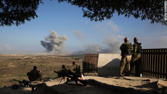 Israeli soldiers watch a bomb explode along the border with Gaza before the 12-hour cease-fire on July 26.