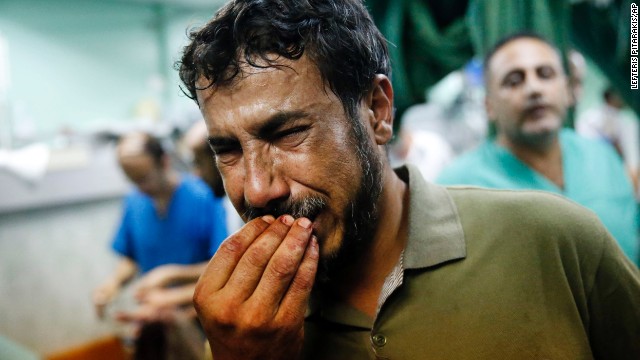 A Palestinian man cries after bringing a child to the Kamal Adwan hospital in Beit Lahiya on Thursday, July 24. The child was wounded in a strike on a school that was serving as a shelter for families in Gaza. It's unclear who was behind the strike. The Israeli military said it was "reviewing" the incident, telling CNN that a rocket fired from Gaza could have been responsible.