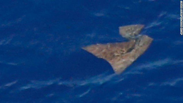An object floating in the southern Indian Ocean is seen from a Royal New Zealand Air Force P-3K2 Orion aircraft searching for the missing jet on Saturday, March 29. Ships participating in the search retrieved new debris Saturday, but no objects linked to the missing plane, according to Australian authorities. 