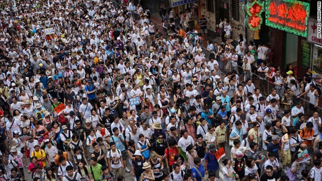 A river of protesters, wearing white T-shirts to show their support for democracy, flowed through Hong Kong's Causeway Bay. Police counted more than 98,000 participants.