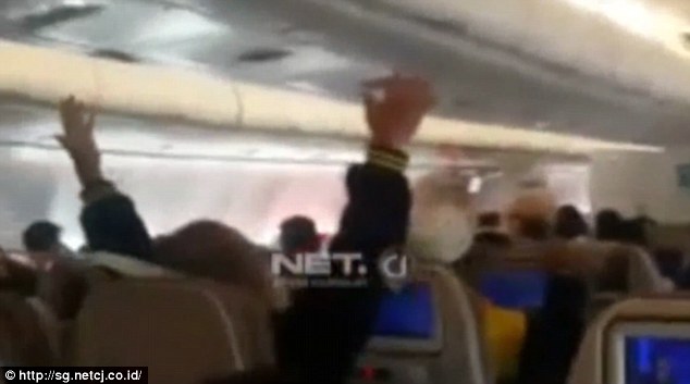 Passengers were filmed raising their hands in the air as the plane was rocked by severe turbulence as it came in to land in Jakarta