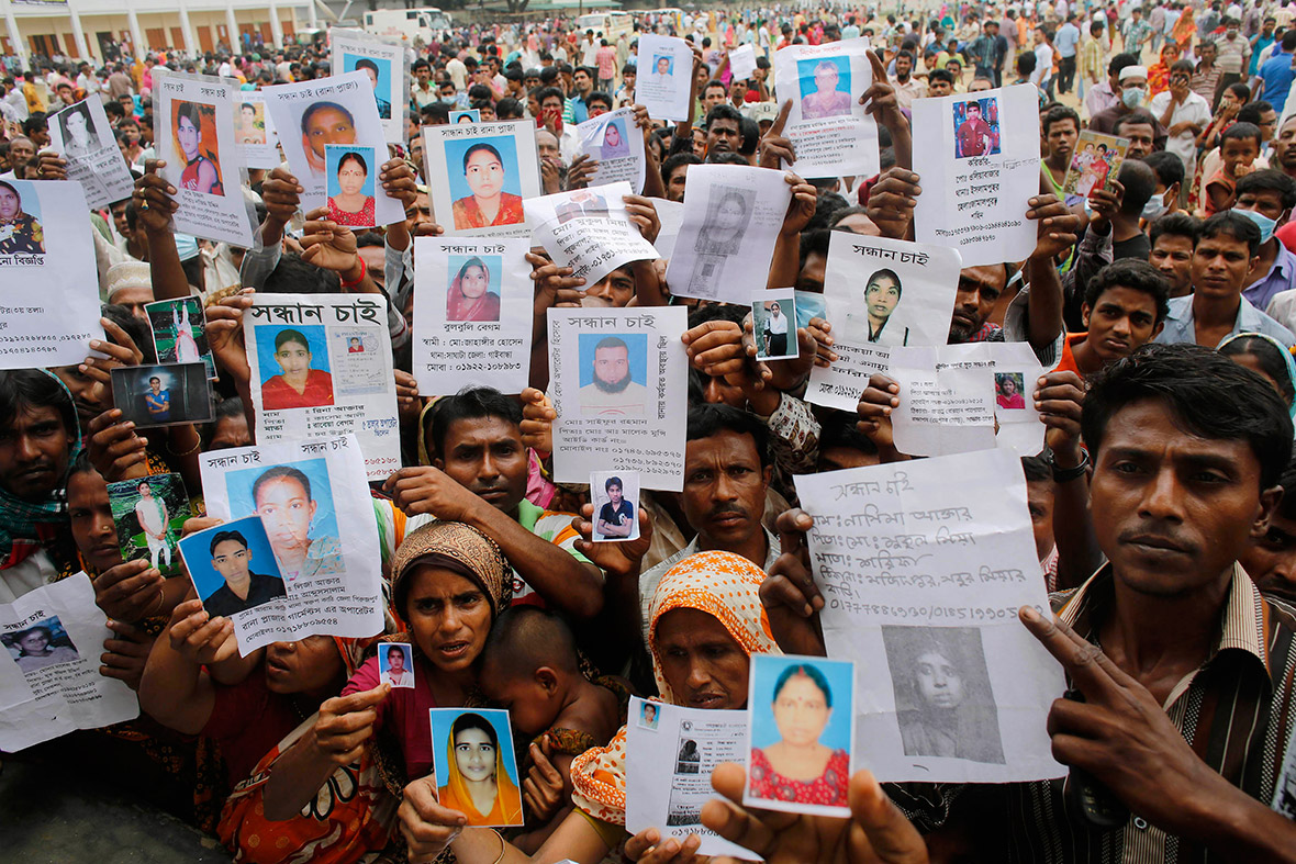 April 28, 2013: Relatives hold up photos of some of the more than 900 garment workers still missing, believed to be trapped under the rubble