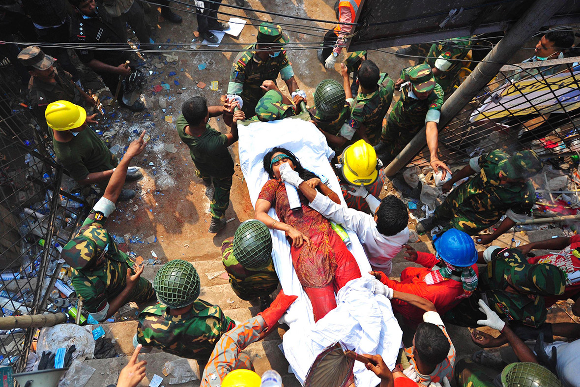 April 27, 2013: Rescue workers carry a garment worker who was pulled alive from the rubble three days after Rana Plaza collapsed