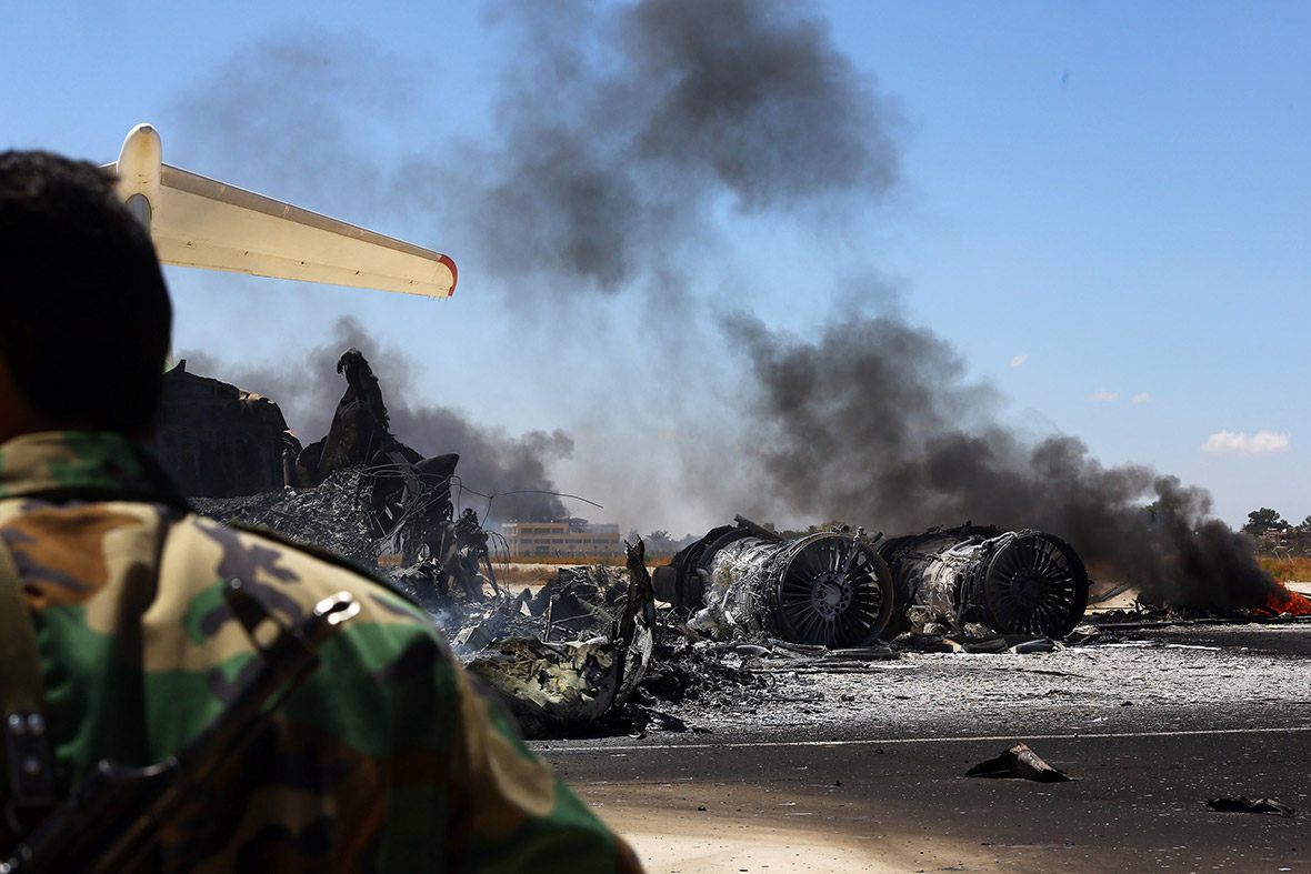July 16, 2014: The remains of a plane smoulder at Tripoli international airport after coming under rocket fire for a fourth straight day, in attacks aimed at ousting anti-Islamist fighters who control the facility