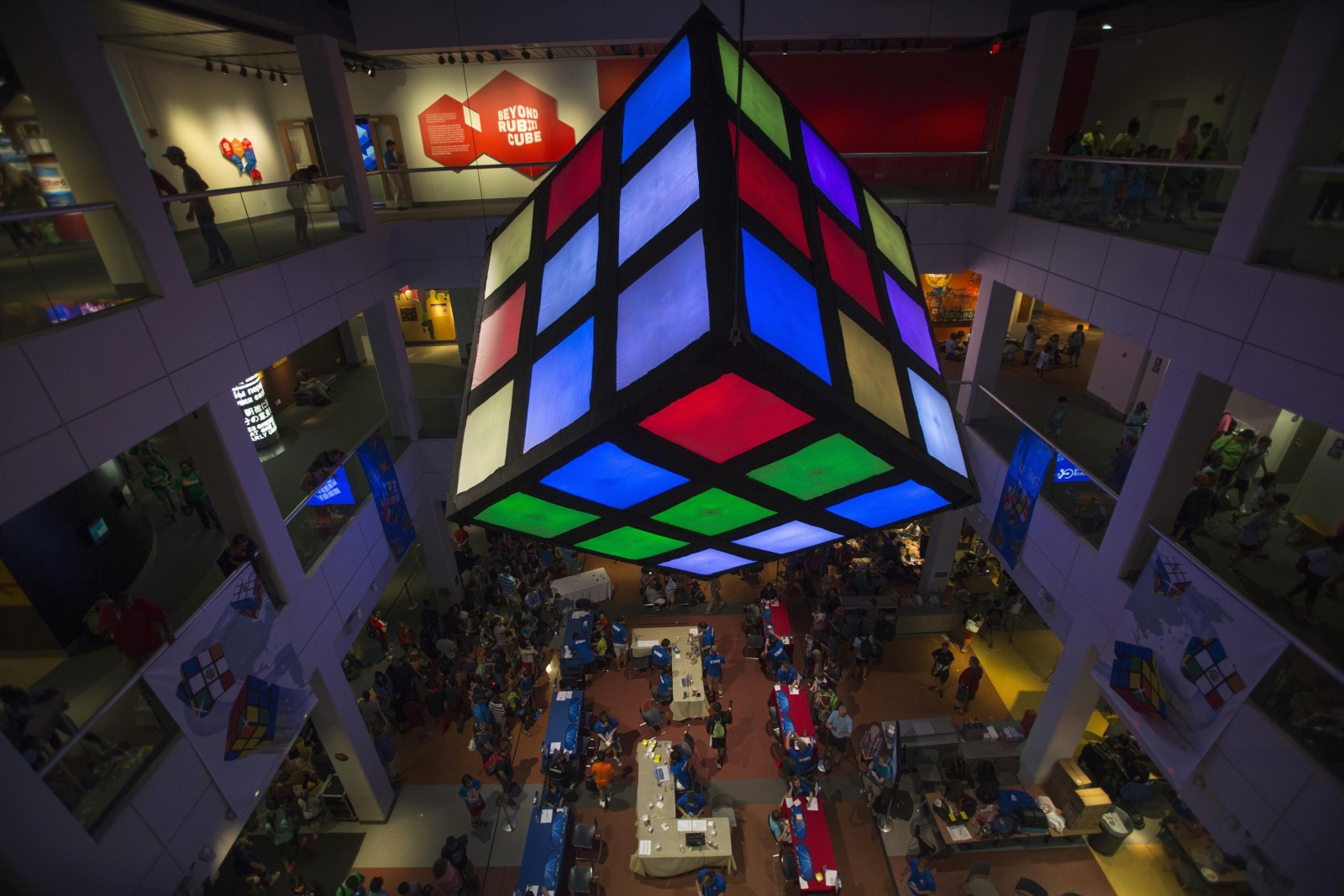 Rubik's Cube looks down over the crowd of participants