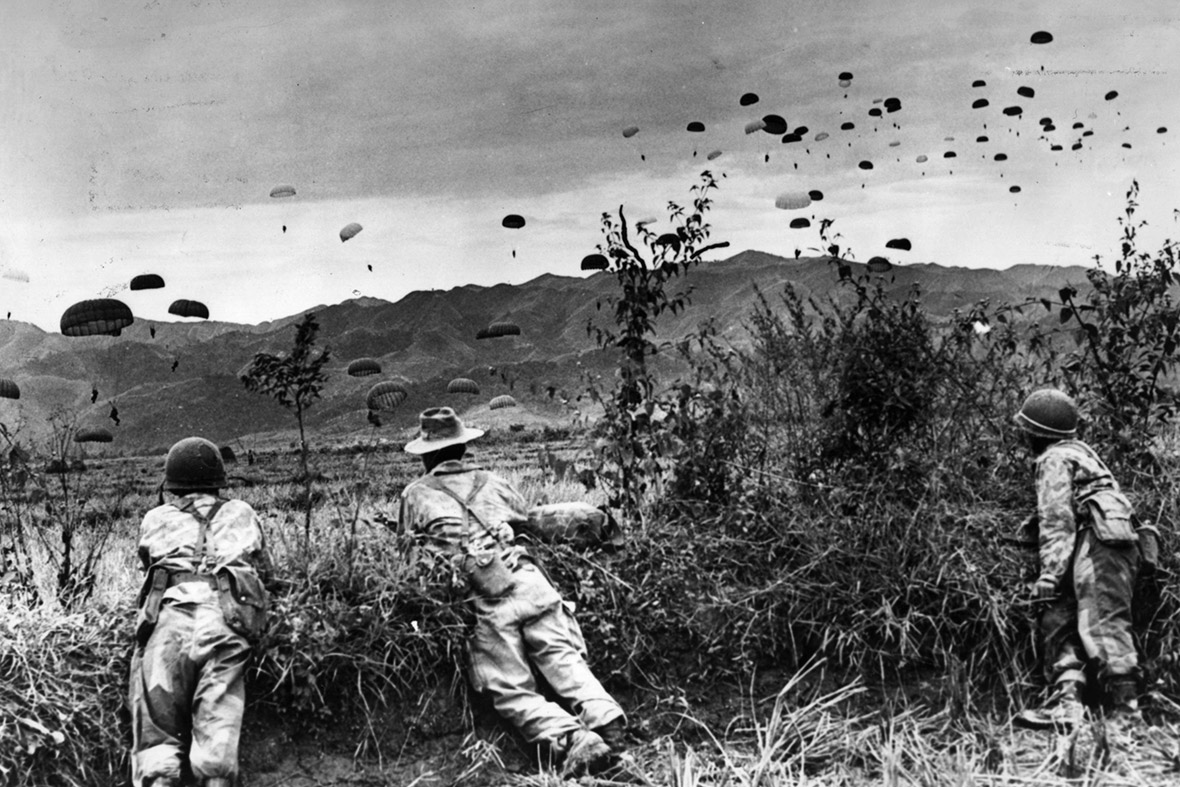 French parachutists watch comrades being dropped over Dien Bien Phu, an enemy stronghold which was captured by the paratroopers during the Indochina war. However they were subsequently besieged and defeated by the Viet Minh