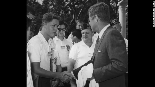 A young Clinton shakes hands with President John F. Kennedy while other American Legion Boys Nation delegates look on during a trip to the White House in 1963.