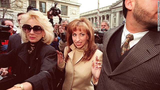 Paula Jones, center, arrives at the office of a lawyer representing President Clinton in Washington on January 17, 1998. The former Arkansas state employee filed a federal civil lawsuit in 1994 accusing Clinton of making "persistent and continuous" unwanted sexual advances during a conference in 1991, when he was governor. The President agreed to an $850,000 settlement on November 13, 1998.