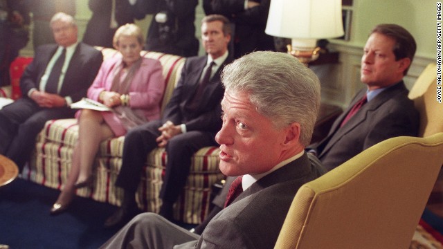 Clinton answers questions from reporters on December 17, 1998, before the start of a meeting with his foreign policy team, including National Security Adviser Sandy Berger, left, Secretary of State Madeleine Albright, Defense Secretary William Cohen and Vice President Al Gore at the White House. After a December 16 military strike on Iraq, Clinton warned Iraqi President Saddam Hussein against threatening his neighbors. Clinton also indicated his determination to complete the operations that continued the next day with renewed bombing of Iraqi sites suspected of housing parts to manufacture weapons of mass destruction.