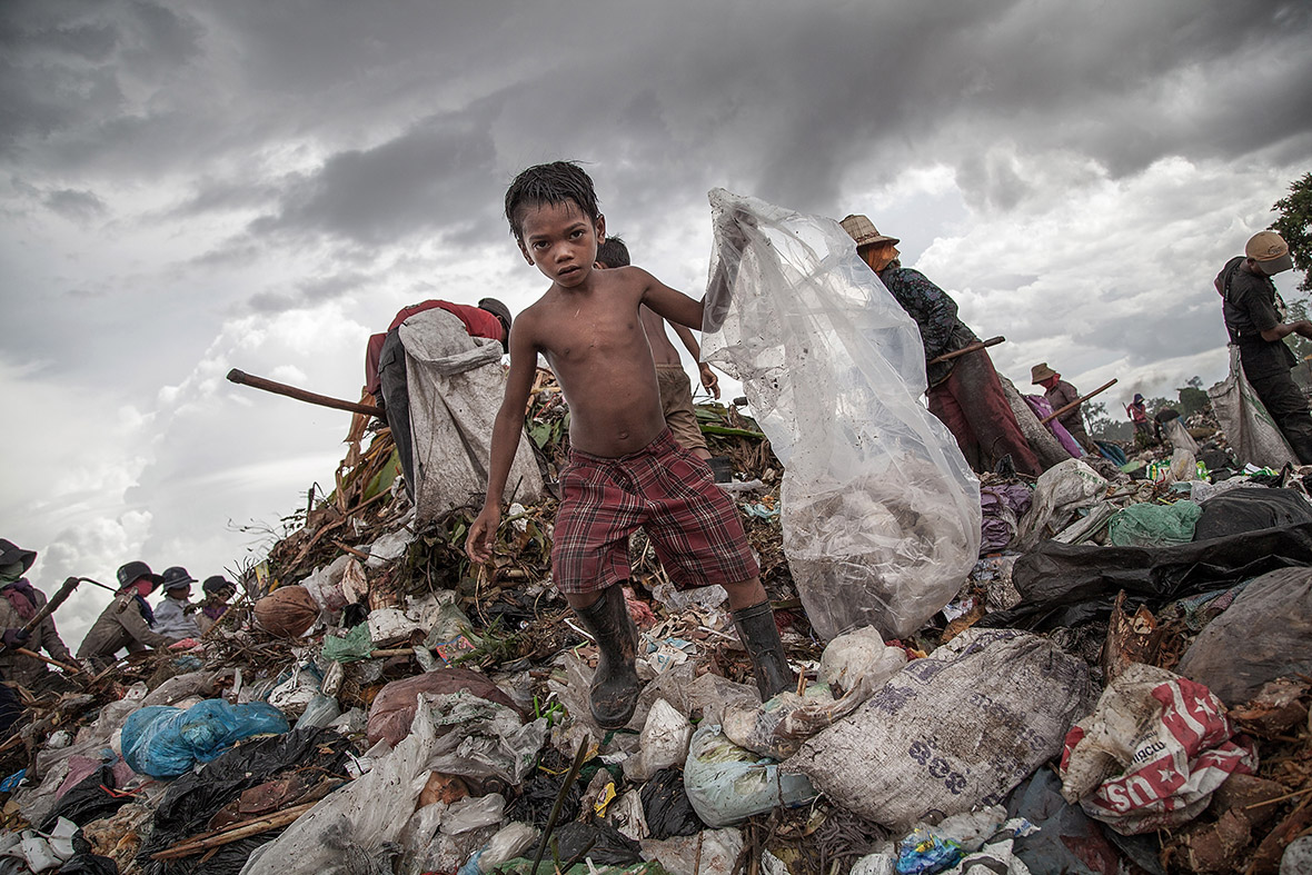 A boy scavenges for recyclable plastic on a rubbish tip in Siem Reap, Cambodia. Dozens of children work every day in the Anlong Pi landfill, which is situated only few kilometres aways from the world famous Angkor temples.