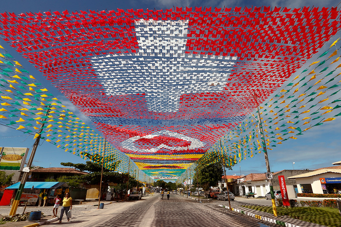 Flags of the participants in the 2014 World Cup are hung over a street in the town of Santa Cruz Cabralia, north of Porto Seguro, Brazil.