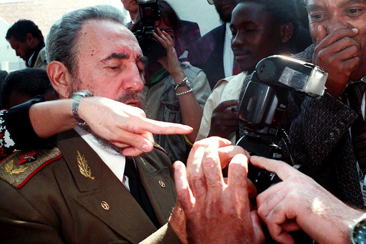 10 May 1994: Castro gets a quick photographic lesson from photographers, before South African President Nelson Mandela's inauguration at the Union Buildings in Pretoria.