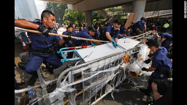 Police dismantle barricades from the streets in Hong Kong on October 14.