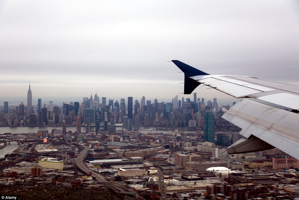 The other side: This file photo shows the midtown Manhattan skyline as a plane lands at LaGuardia Airport