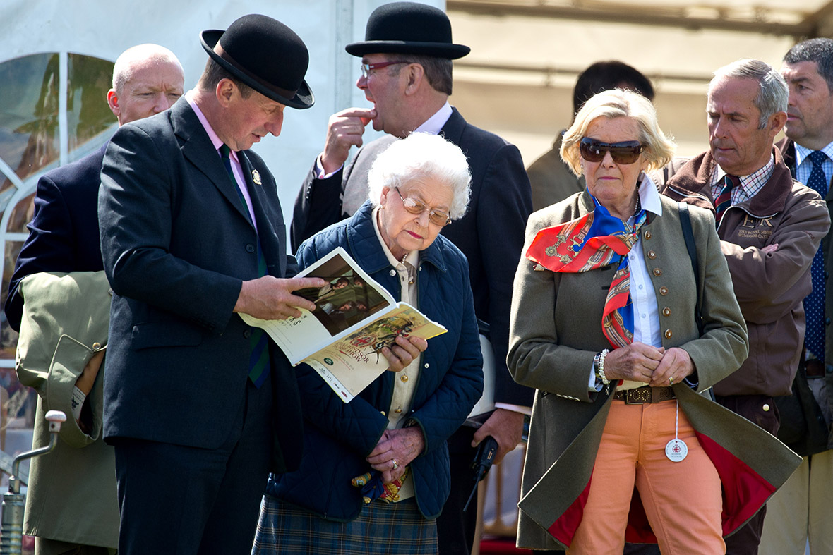 The Queen studies the programme at the Royal Windsor Horse Show
