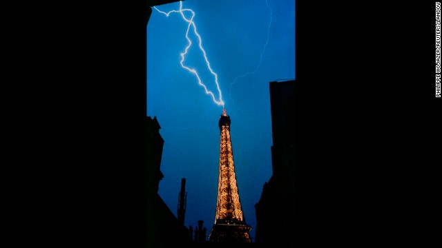 A lightning bolt strikes the top of the Eiffel Tower during a thunderstorm in 1992.