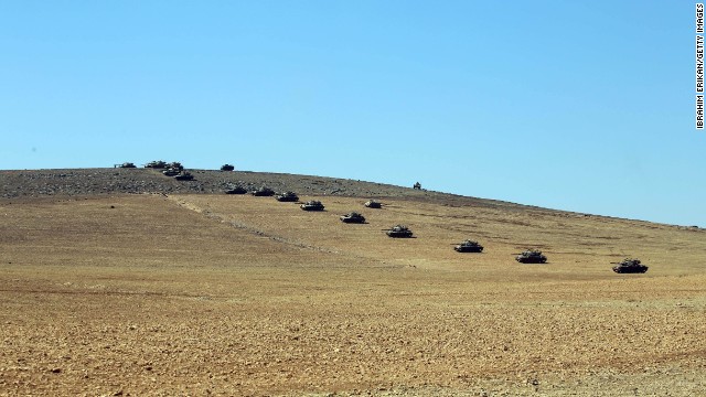Turkish tanks are lined up at the Turkey-Syria border in Sanliurfa, Turkey, on October 6.