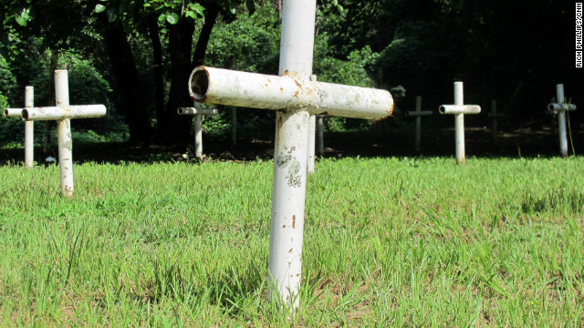 Metal pipe crosses mark the graves.