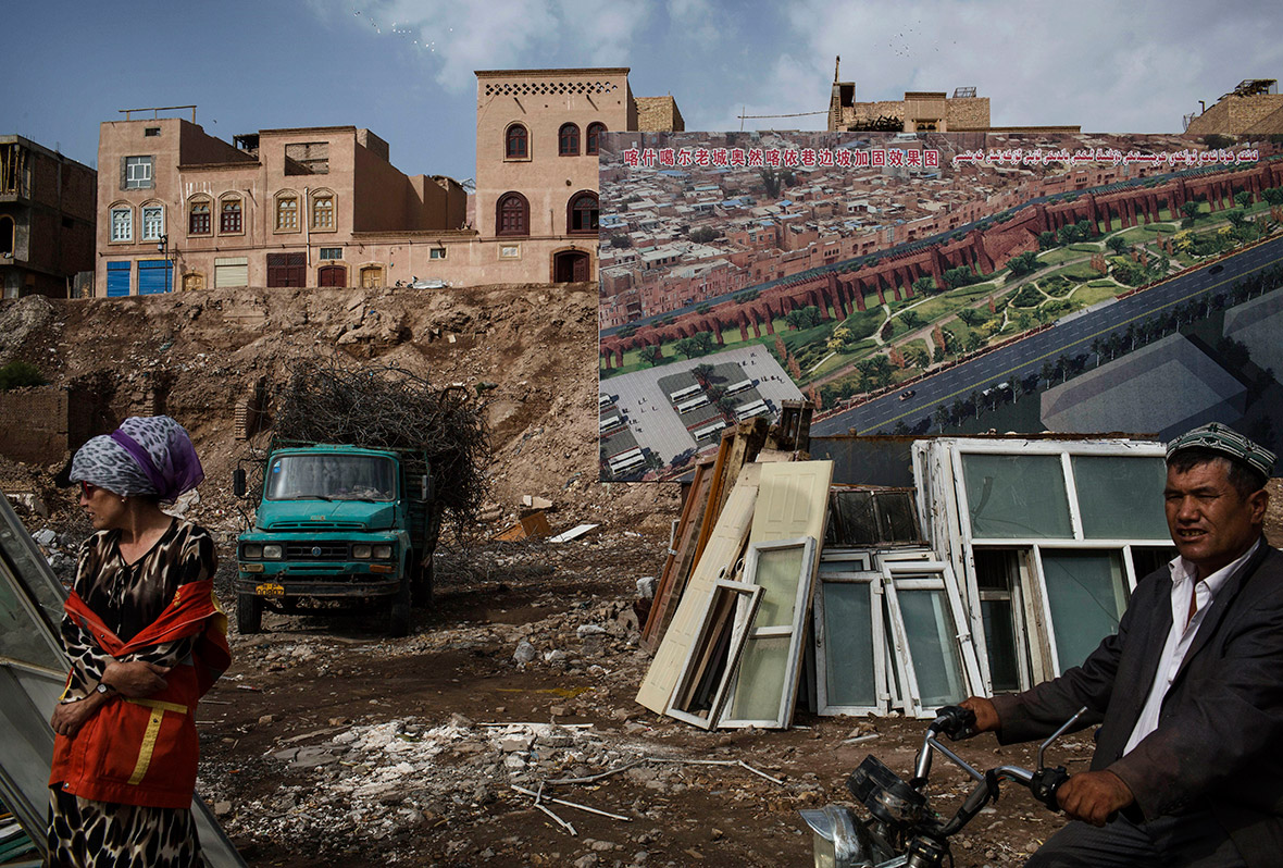 A billboard showing plans for the redevelopment of Kashgar is seen in an area where traditional homes have been demolished by local authorities