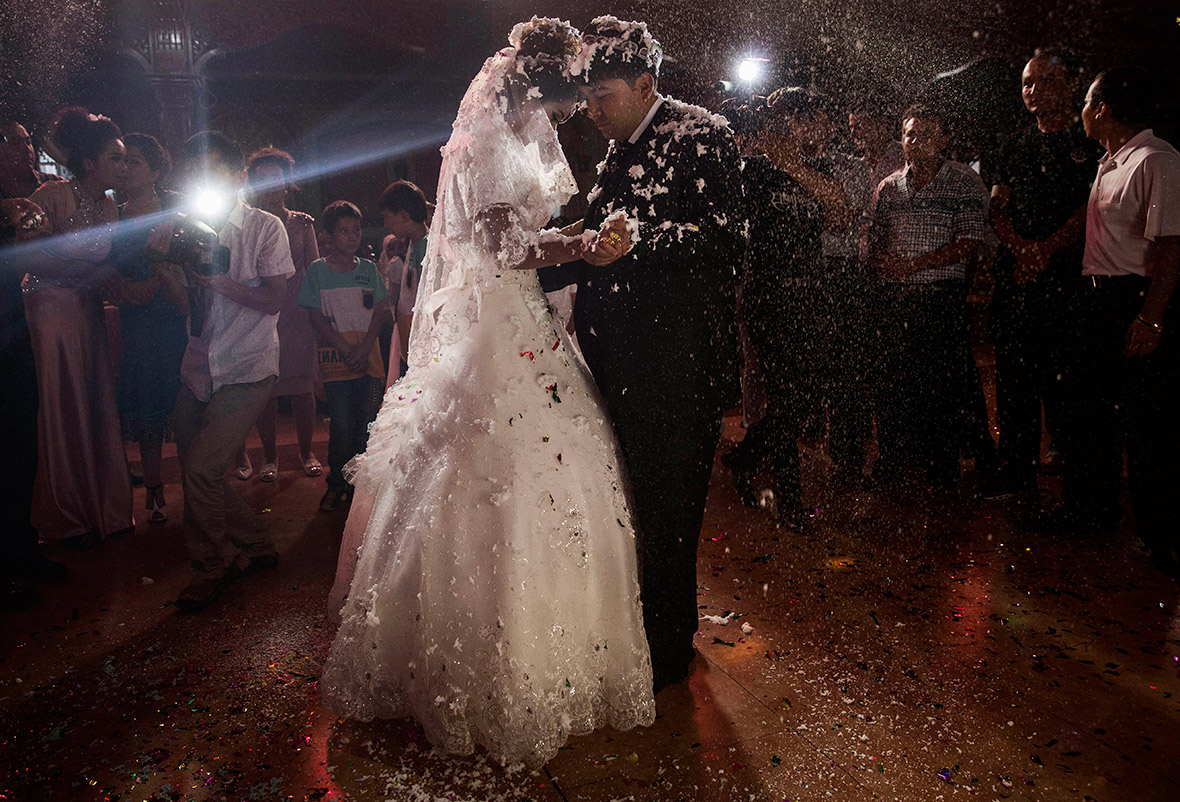 A Uighur couple are showered with confetti as they have the first dance at their wedding celebration