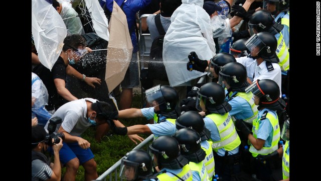 <strong>September 28:</strong> Riot police use pepper spray as they clash with pro-democracy protesters outside the government headquarters in Hong Kong. <a href='http://ift.tt/1t7KHk5'>Demonstrations began</a> in response to China's decision to allow only Beijing-vetted candidates to stand in the city's 2017 election for chief executive. Protesters say Beijing has gone back on its pledge to allow universal suffrage in Hong Kong, which was promised "a high degree of autonomy" when it was handed back to China by Britain in 1997. The umbrella has become the defining image of the protest movement, used to shield protesters from tear gas and the elements.