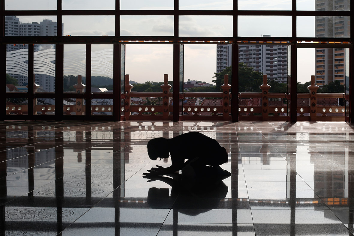 A devotee prays at Kong Meng San Phor Kark See Monastery in Singapore