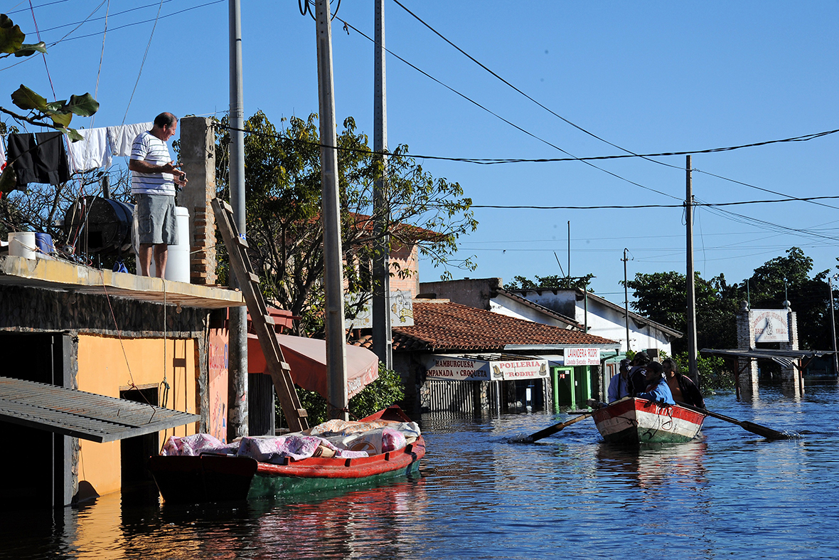 Locals row a small boat in a flooded neighbourhood in Asuncion, the capital of Paraguay. The Paraguay river has risen nearly 6.5 feet (2 metres) above normal