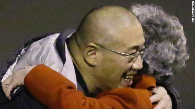 Kenneth Bae, who had been held in North Korea since 2012, greets his mother Myunghee Bae after arriving, Saturday, Nov. 8, 2014, at Joint Base Lewis-McChord, Washington, after Bae and Matthew Todd Miller, who was held in North Korea since April, 2014, were freed during a top-secret mission by James Clapper, U.S. director of national intelligence. 