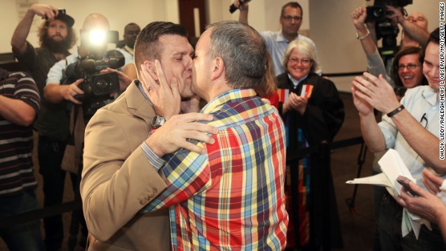 Chad Biggs, left, and his fiancé, Chris Creech, say their wedding vows at the Wake County Courthouse in Raleigh, North Carolina, on Friday, October 10, after a federal judge ruled that same-sex marriage can begin there.