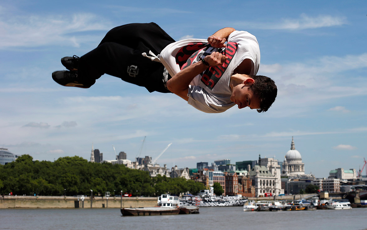 Parkour enthusiast Luke Webb practices a flip along the Thames on the South Bank in London.