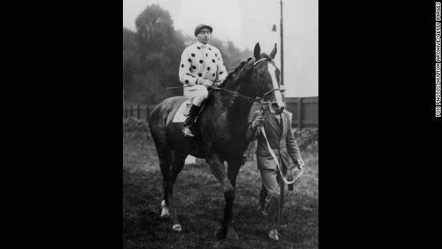 Omaha -- the son of Gallant Fox -- won the Triple Crown in 1935. Here, jockey Pat Beasley rides the horse in 1936.