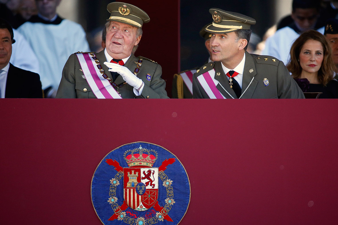 Spain's Crown Prince Felipe listens to his father King Juan Carlos as they attend a ceremony marking the bicentennial of the creation of the order of Saint Hermenegildo at the Monastery of San Lorenzo de El Escorial, outside Madrid