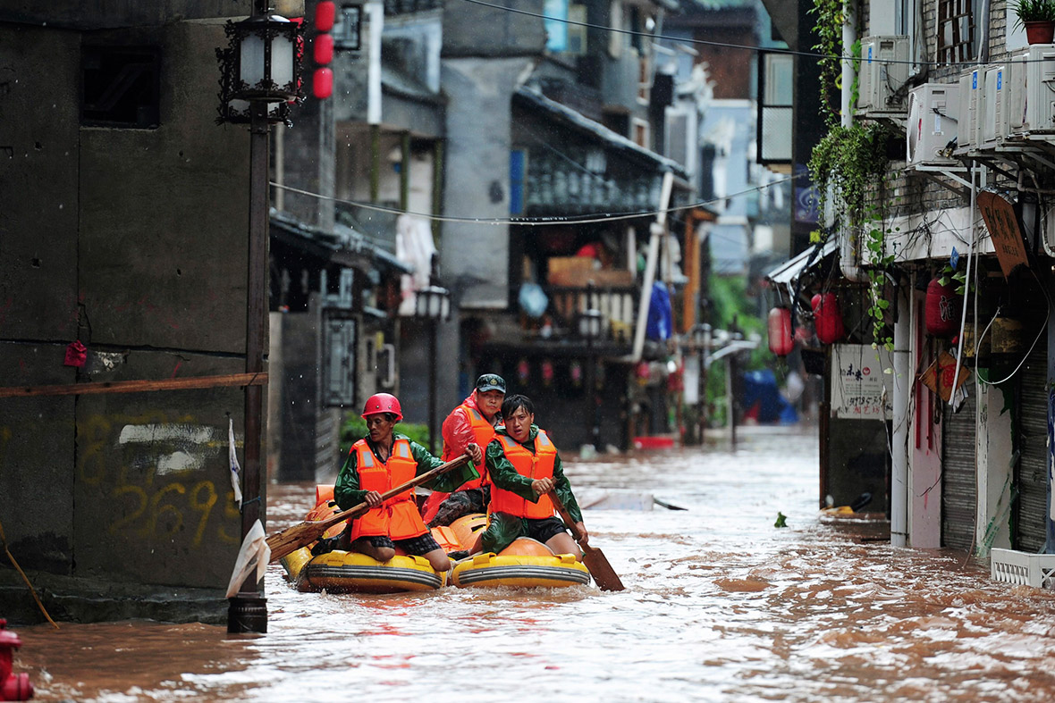 Rescue workers search for people on a flooded street