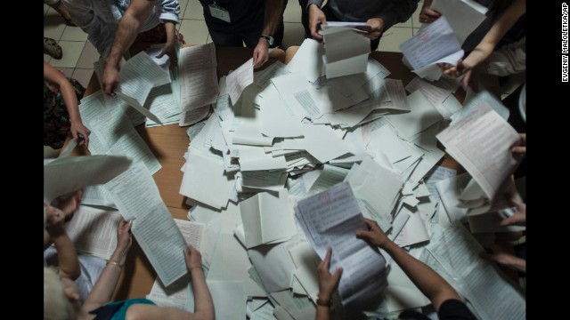 Election commission officials count ballots at a polling station in Kiev on Sunday, May 25.