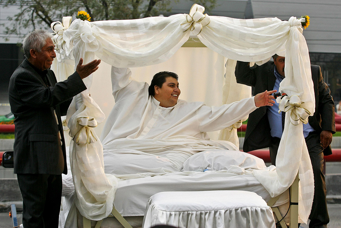 October 26, 2008: Manuel Uribe waves as he is driven on board a truck to go to his wedding in Monterrey, Mexico. Despite shedding 230 kilograms (570 pounds) Uribe had to be carried to the wedding venue on his bed, where he had been confined for years