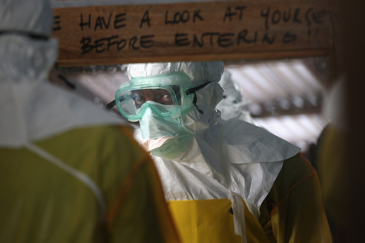 A member of staff checks his protective clothing before entering a high-risk area of the MSF Ebola treatment centre
