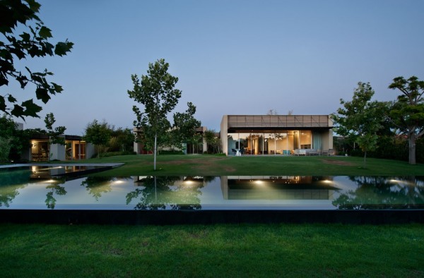 The home's reflecting pool is large, adding a focal point for the sloping yard while also functioning as a stylish border.