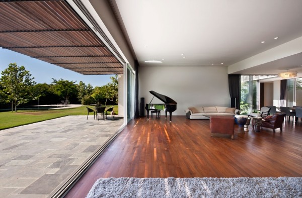 Dark wood floors contrast with soft plush rugs and sofas.